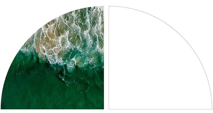 Aerial view of ocean waves with white foam and green water.
